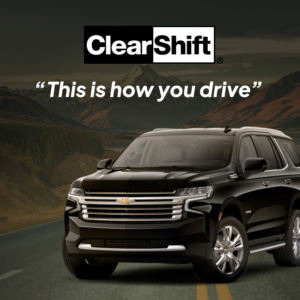 Black Chevrolet SUV parked on a scenic mountain highway with the quote “This is how you drive.”