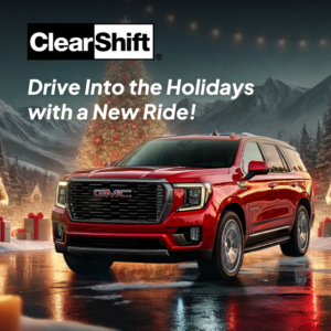 Red GMC Yukon parked with a decorated Christmas tree in the background, promoting holiday car shopping.