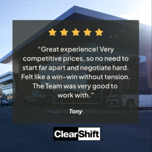 Typed customer review from Tony displayed over a background of the ClearShift dealership building.